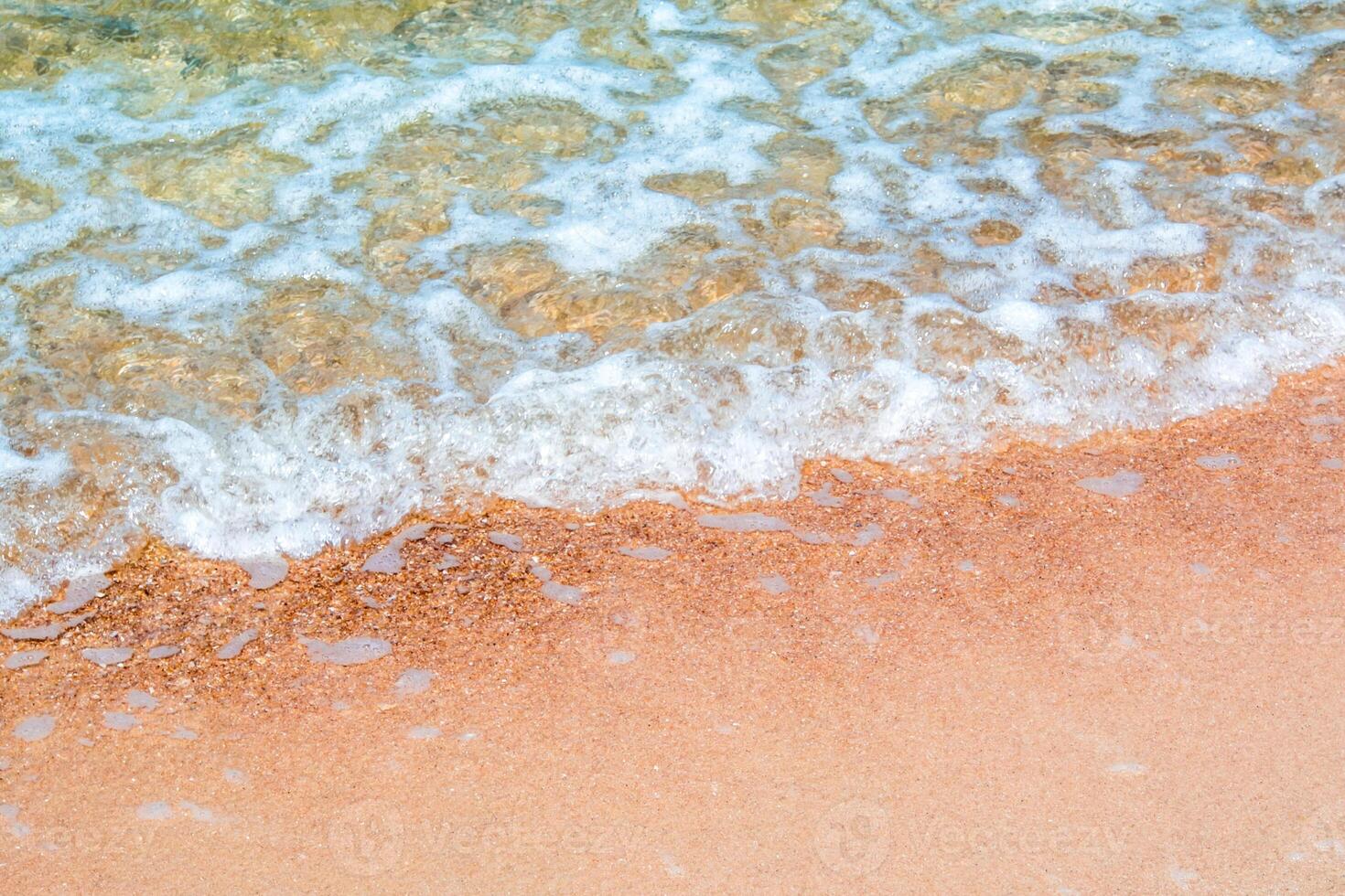 The Bubble of clear sea wave on the beach photo
