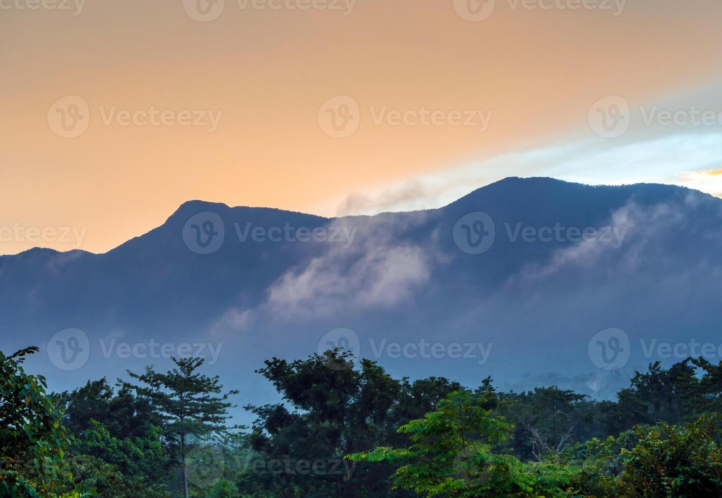 The Colorful Sky and Clouds drifting over the forest mountain in evening time photo