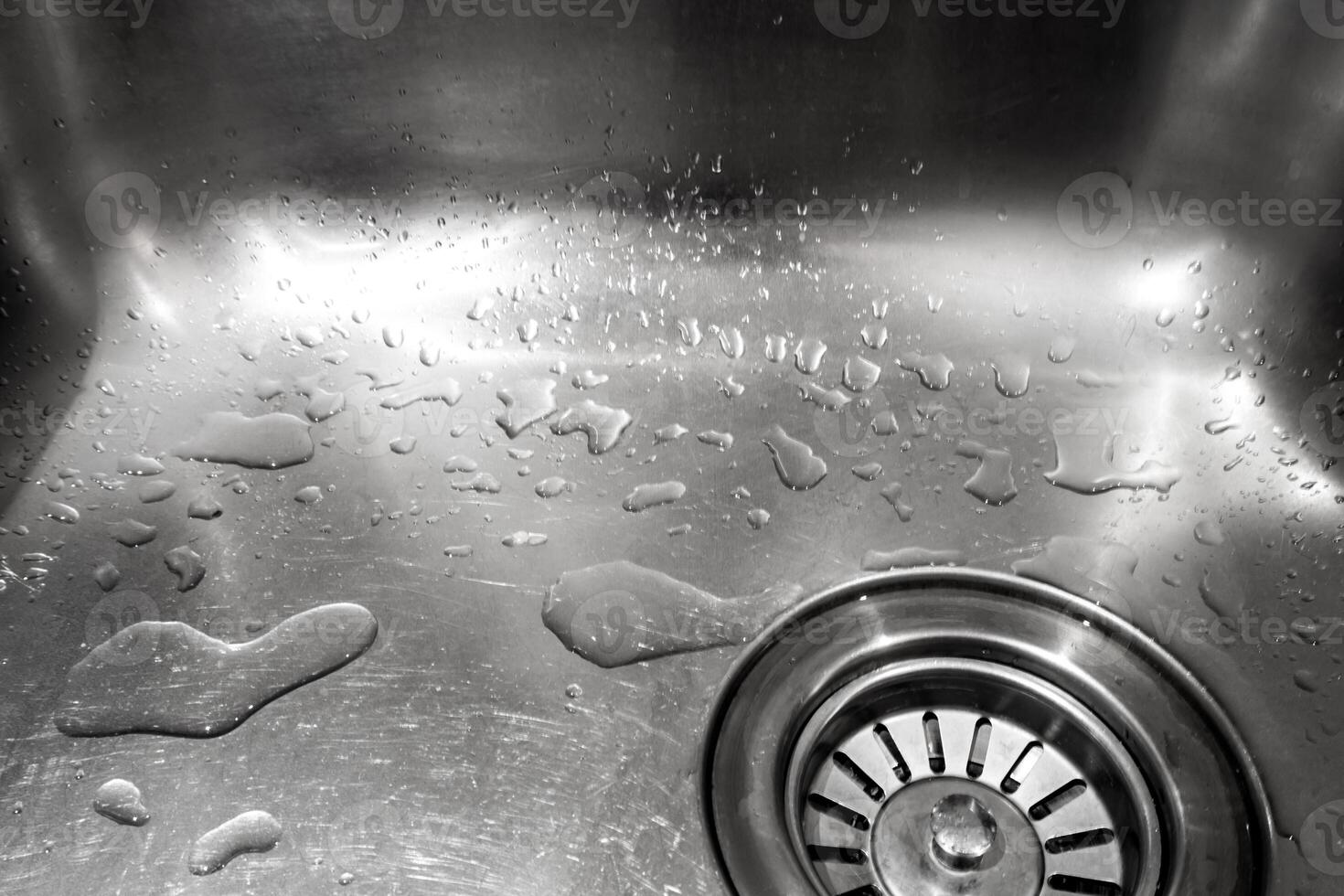 Water drops in the shiny stainless sink photo