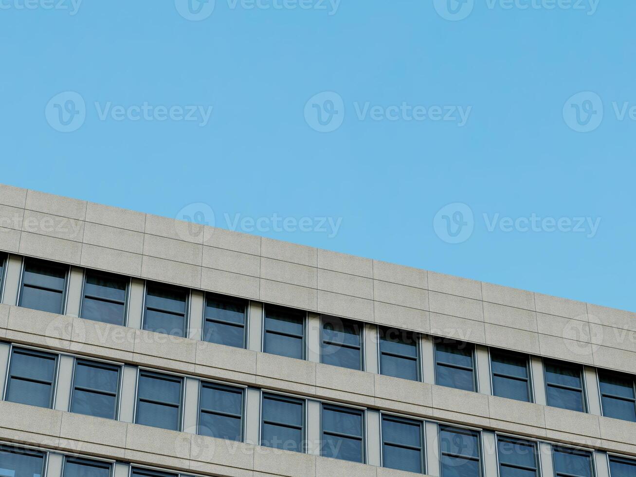 Contemporary architecture with a clean, minimalistic corner and blue sky. photo