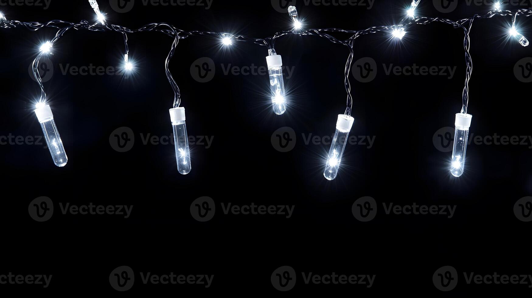 A string of lights with white bulbs hanging from the ceiling photo