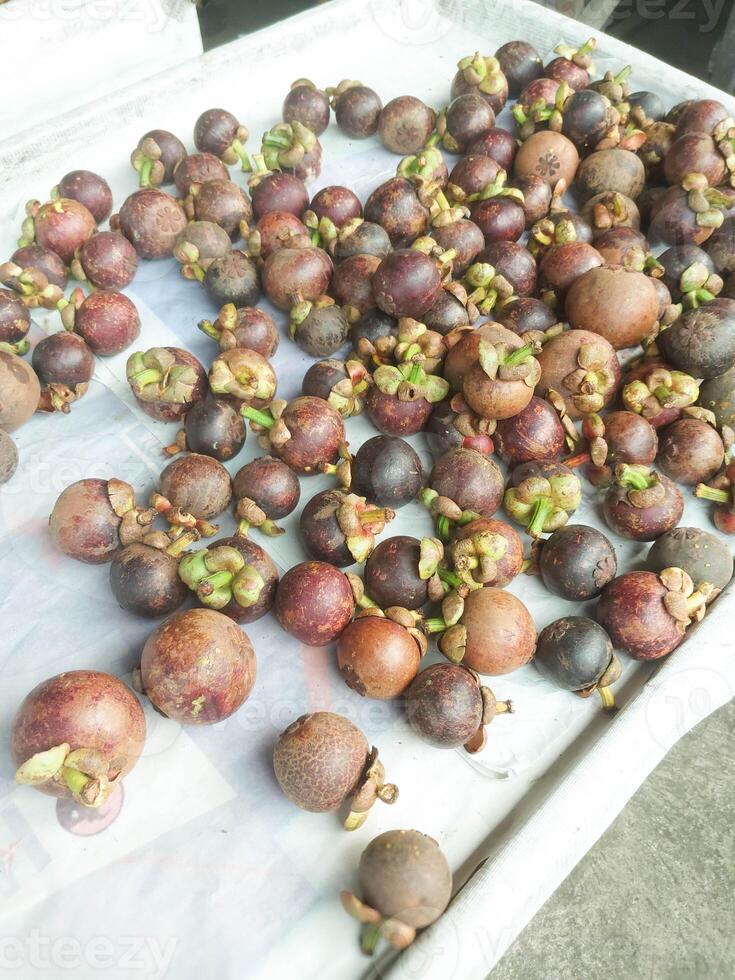 Fresh Mangosteens Displayed at a Traditional Market photo