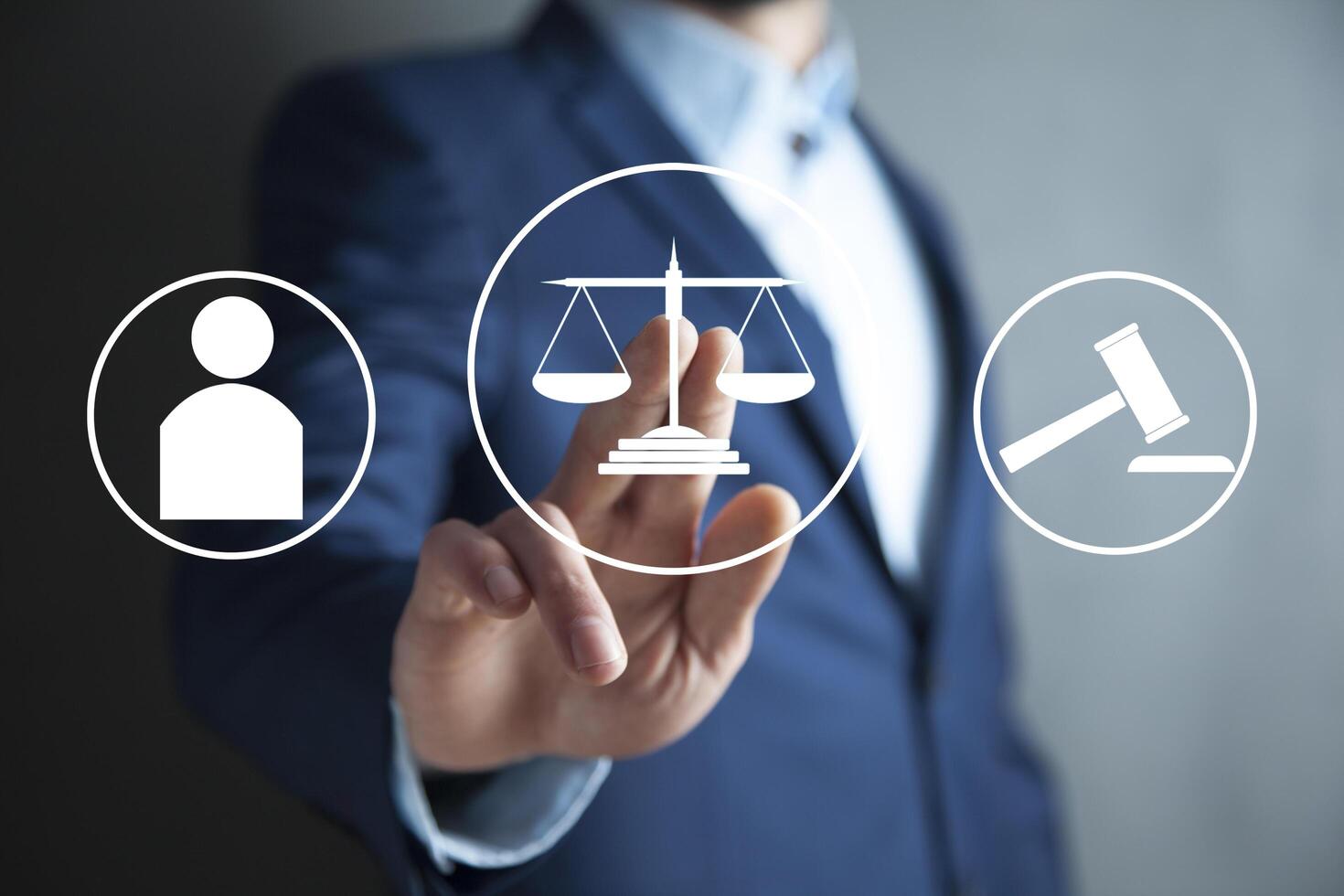 Businessman holding justice icon on virtual screen photo