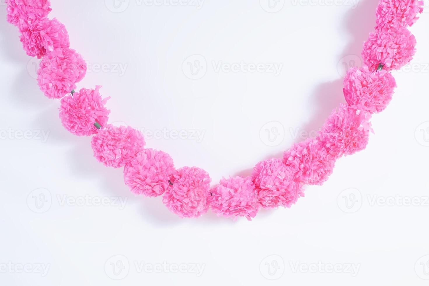 A pink flower necklace with a chain photo