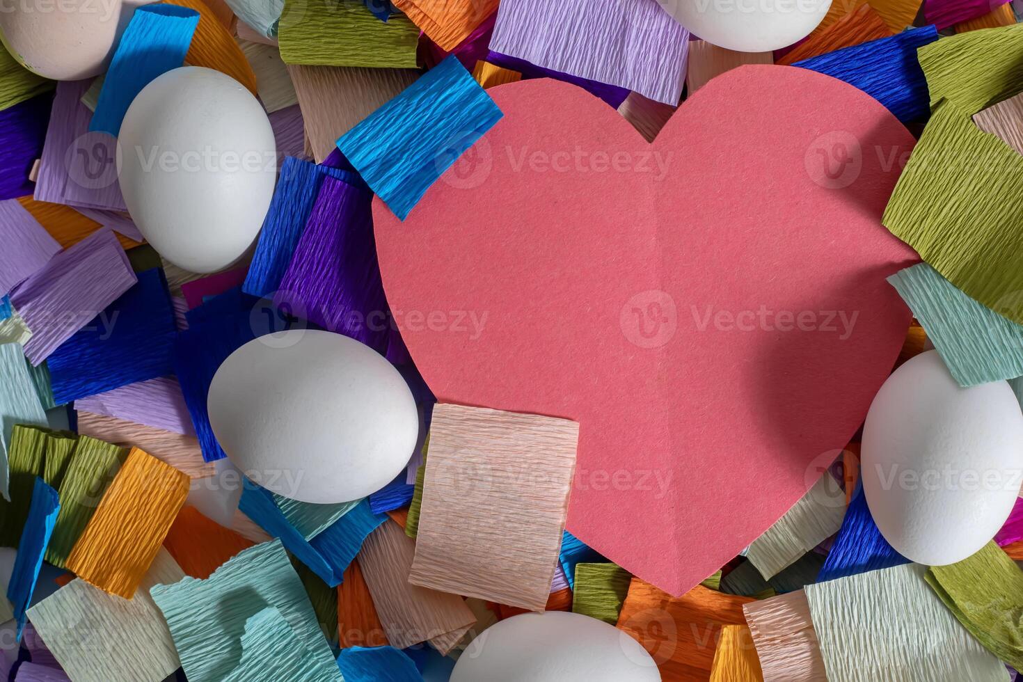 A red heart surrounded by colorful paper photo