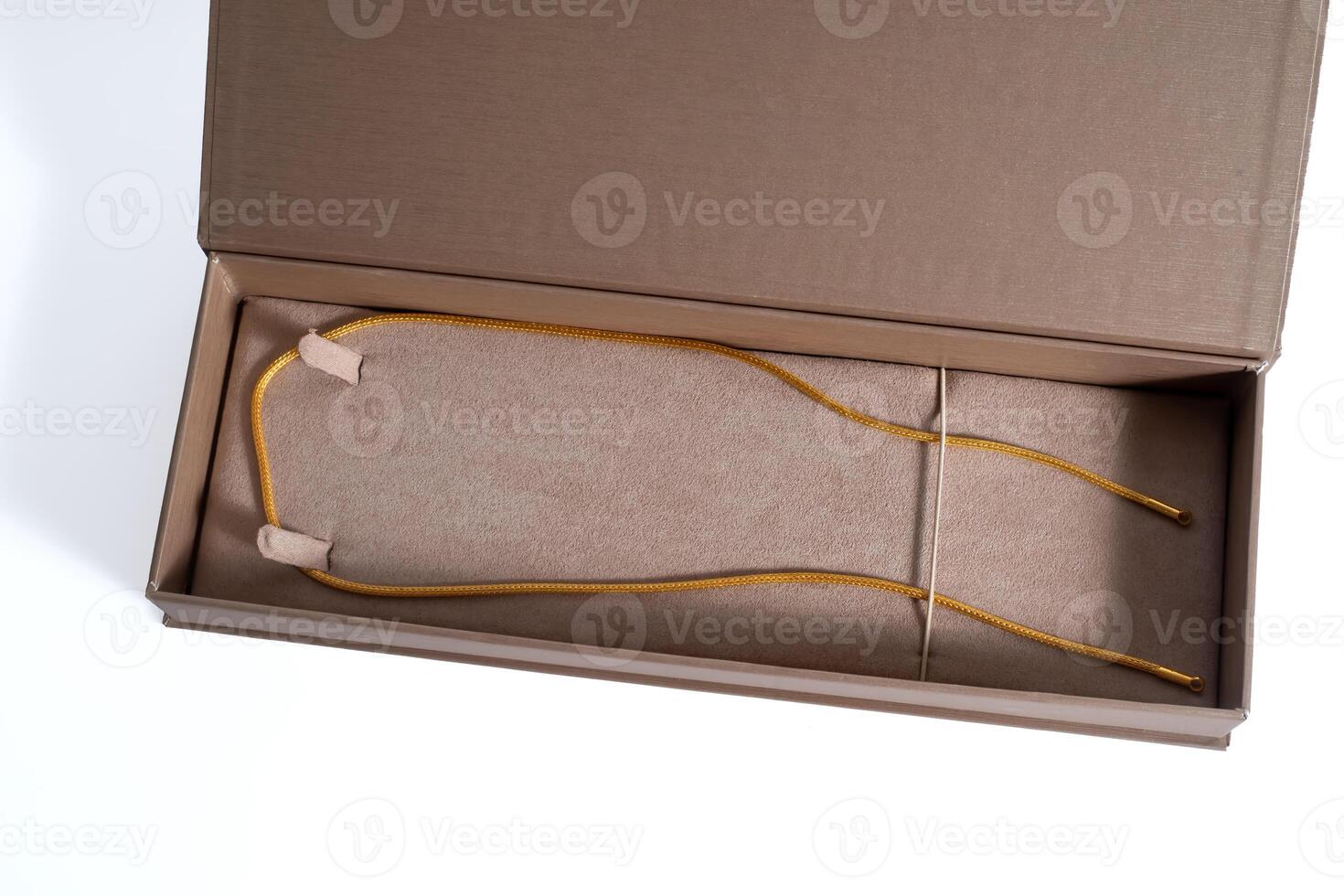 A brown box with yellow cord and a pair of sunglasses inside photo