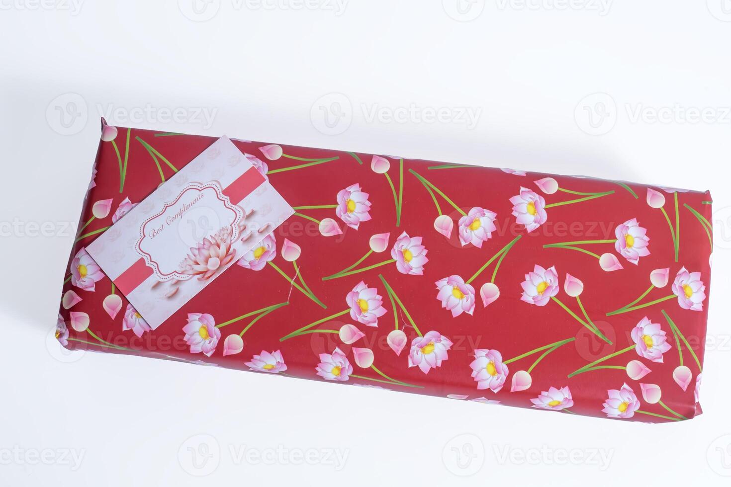 A red wrapping paper with pink flowers on it photo