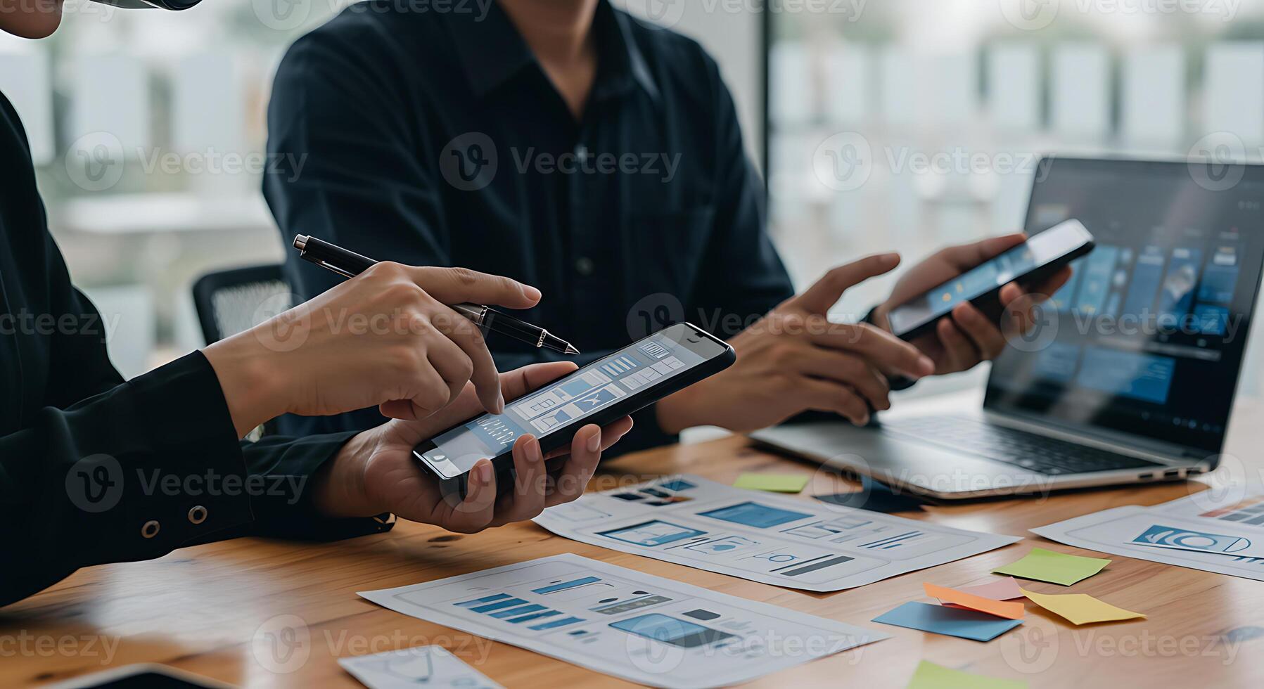 Business Colleagues Collaborating On Project With Smartphones and Laptop At Office photo
