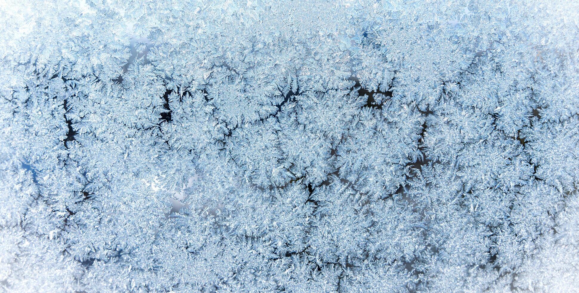 Cold winter background. Beautiful frosty pattern on the window. Close-up. Selective focus. photo
