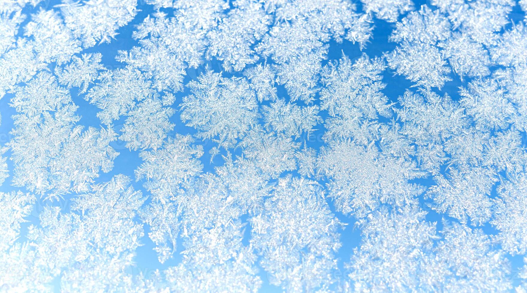 Winter frost pattern on glass. Ice pattern. Texture. Close-up. Selective focus. photo