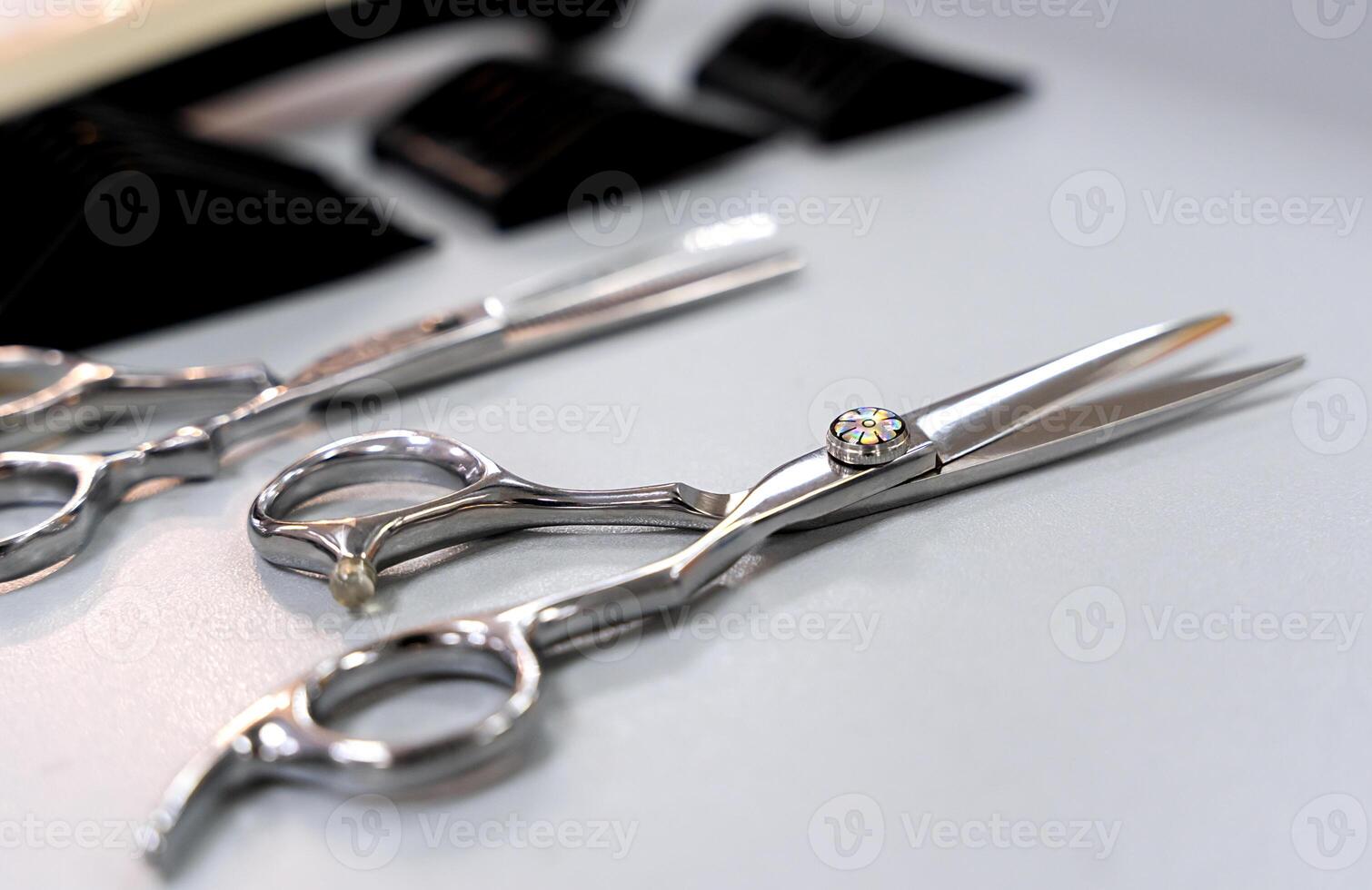 Hairdressing scissors and other accessories on the table. Close-up. Selective focus. photo