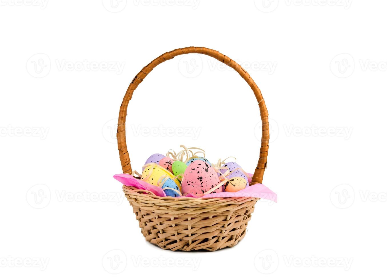 Decorative colorful Easter eggs in a wicker basket isolated on white background. Easter decor. photo
