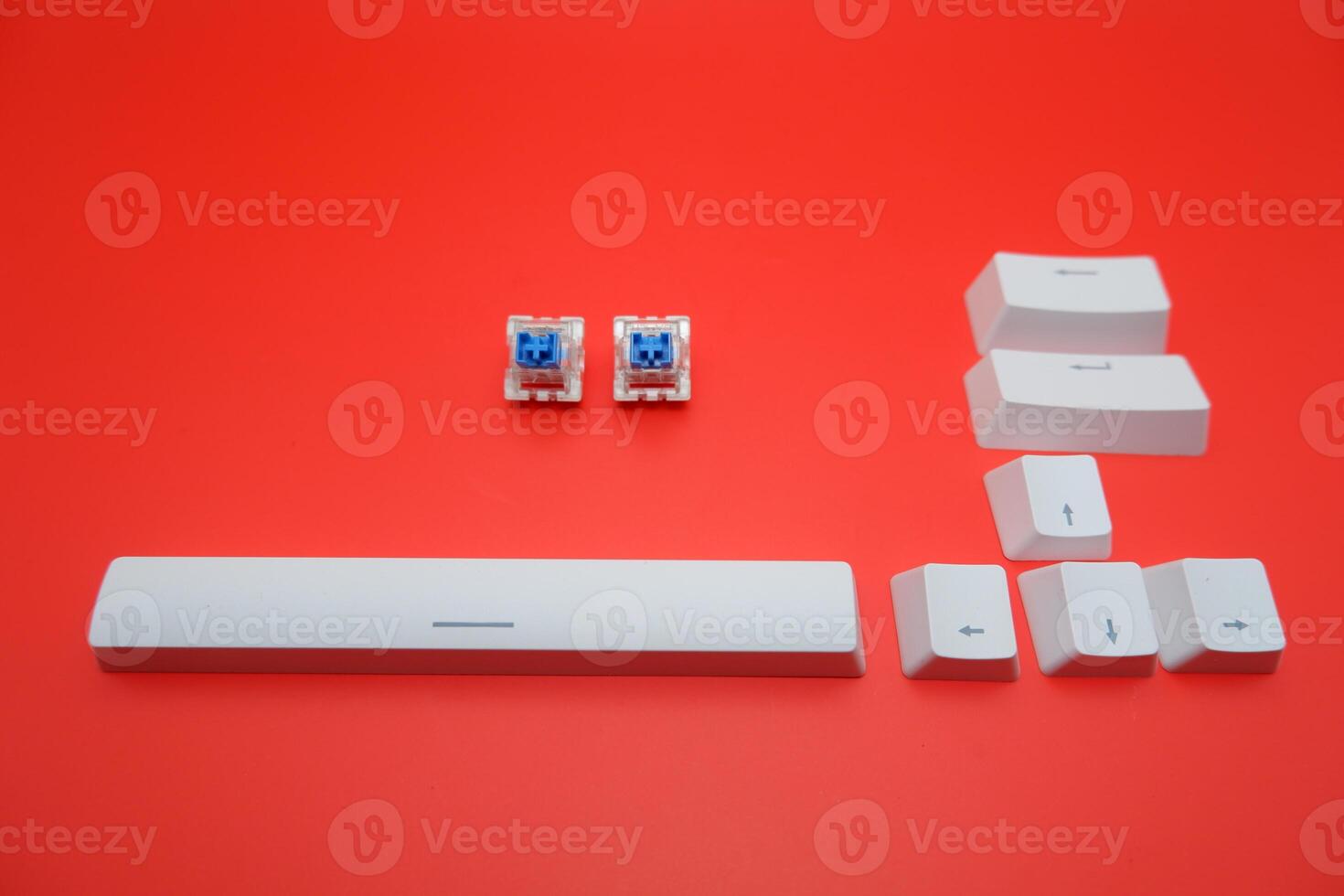 Blue Mechanical Keyboard Switch with Keycaps Isolated on Red Background photo