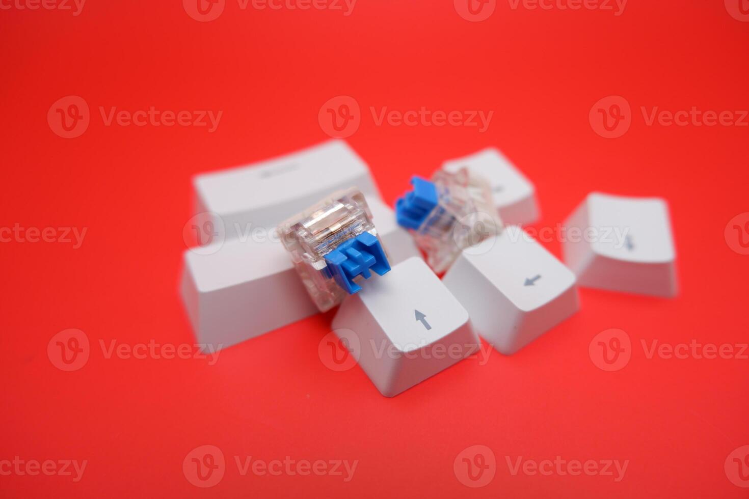 Clicky Blue Switch and Keycaps for Mechanical Keyboard on Red Background photo