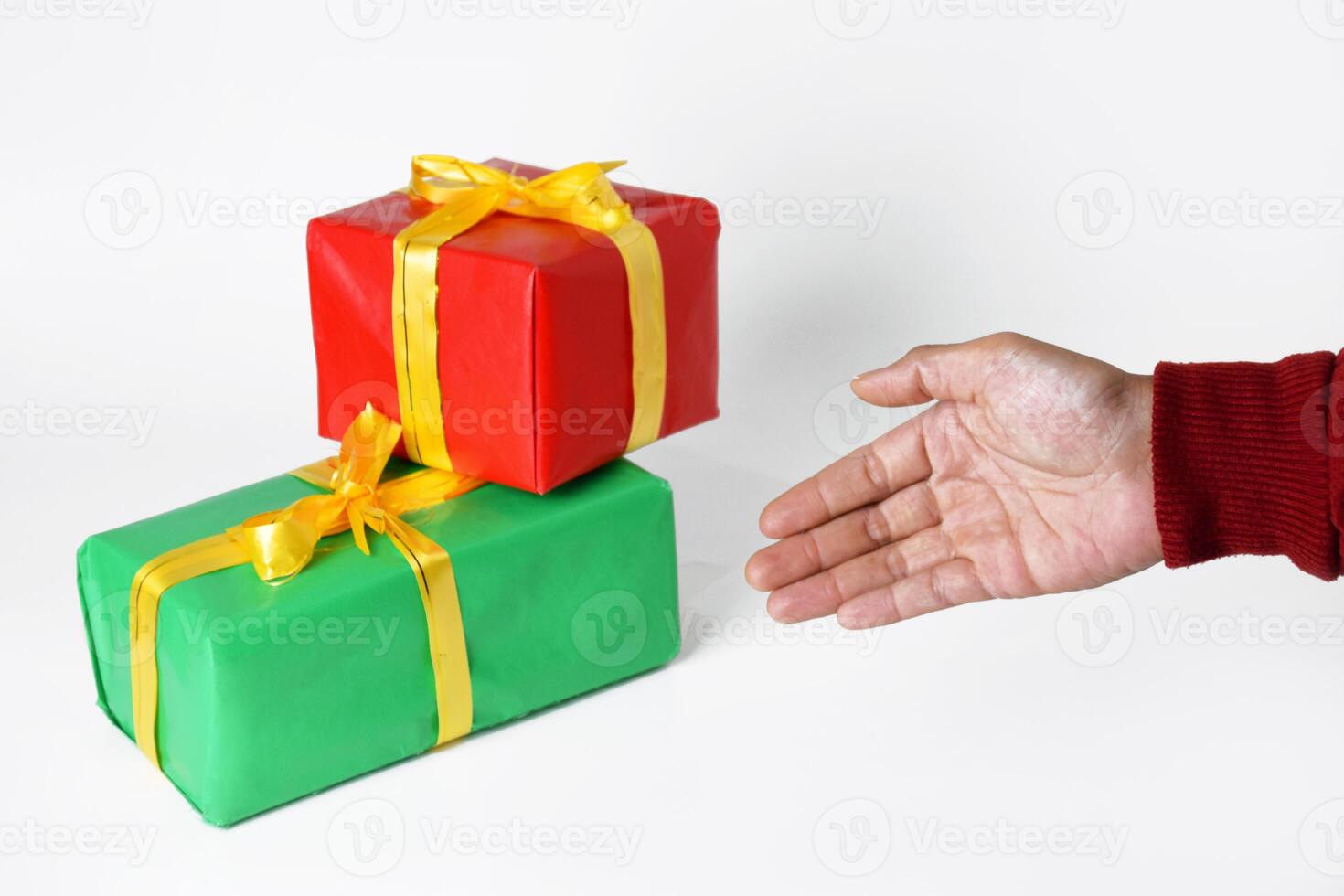 A Hand in Red Sweater Displays a Festive Box photo