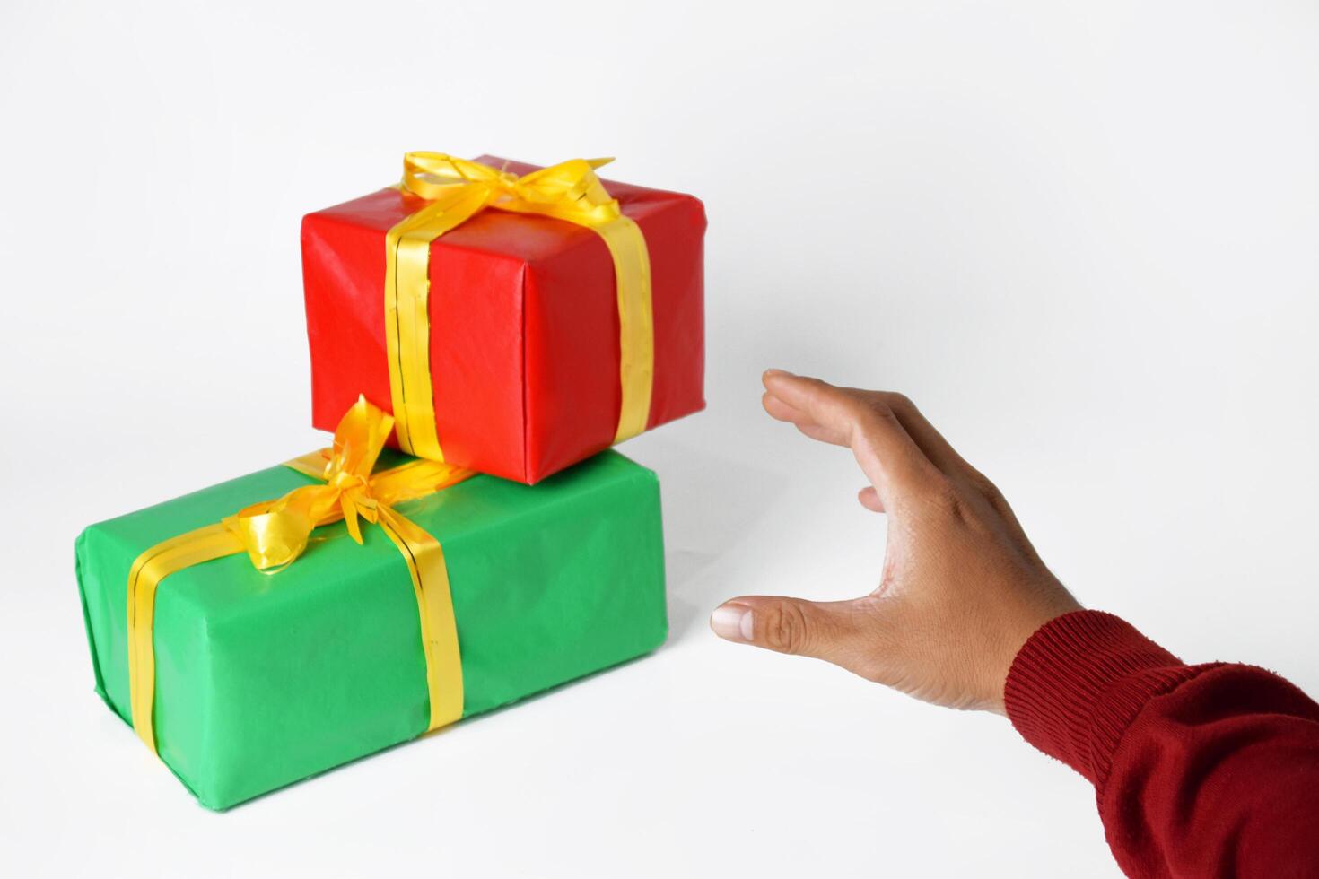 A person's hand in a sweater points with a red and green square finger photo