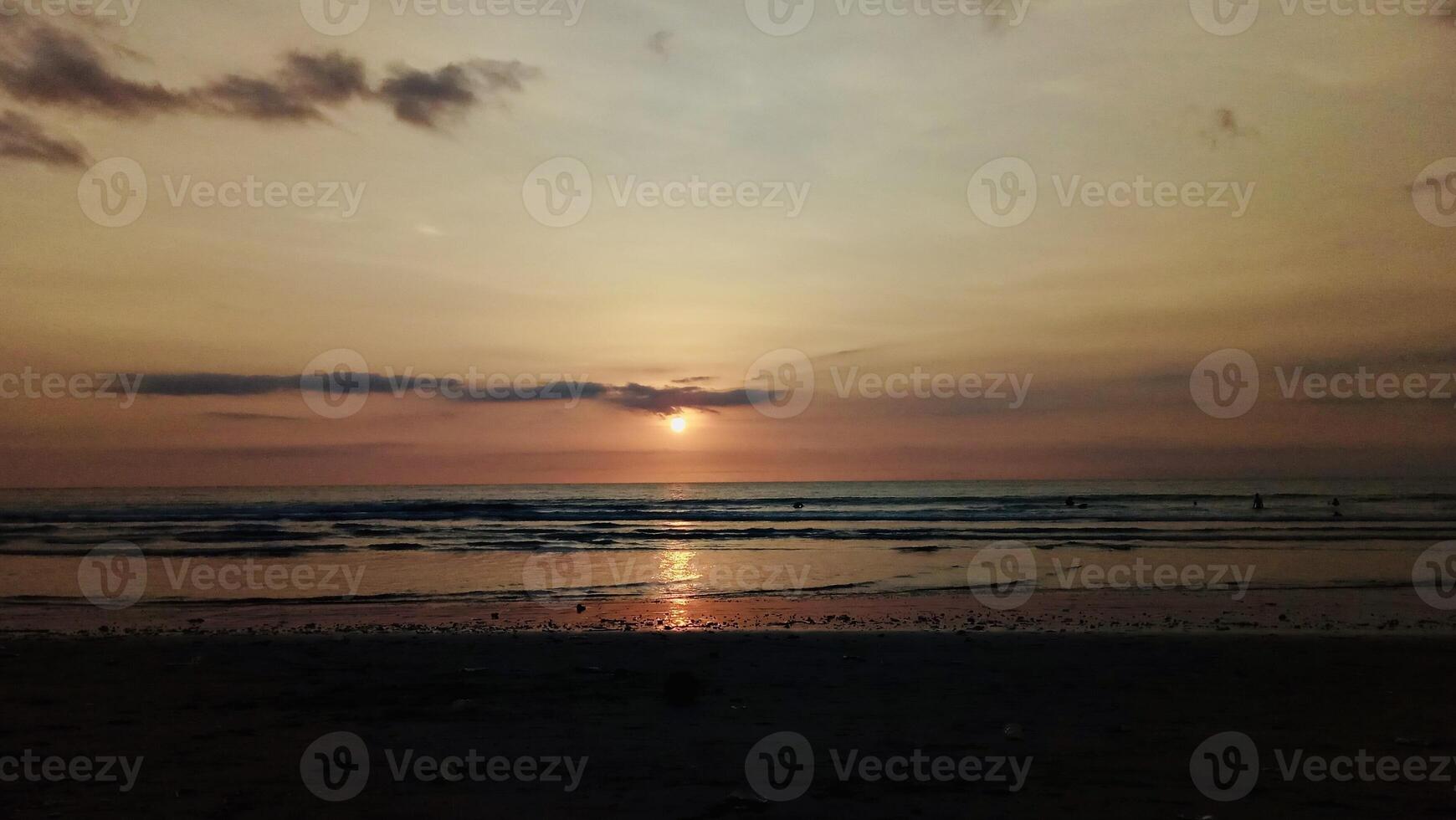 Serene Beach Sunset Over Calm Waters. Kuta Beach Bali photo