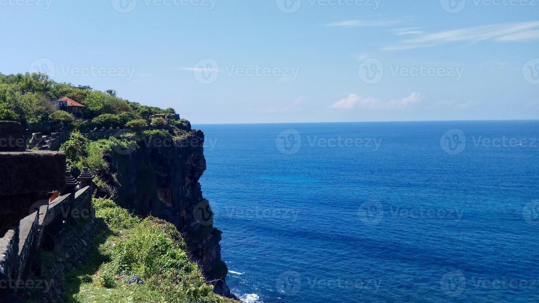 Scenic Coastal View with Lush Greenery. Pura Uluwatu Bali. photo