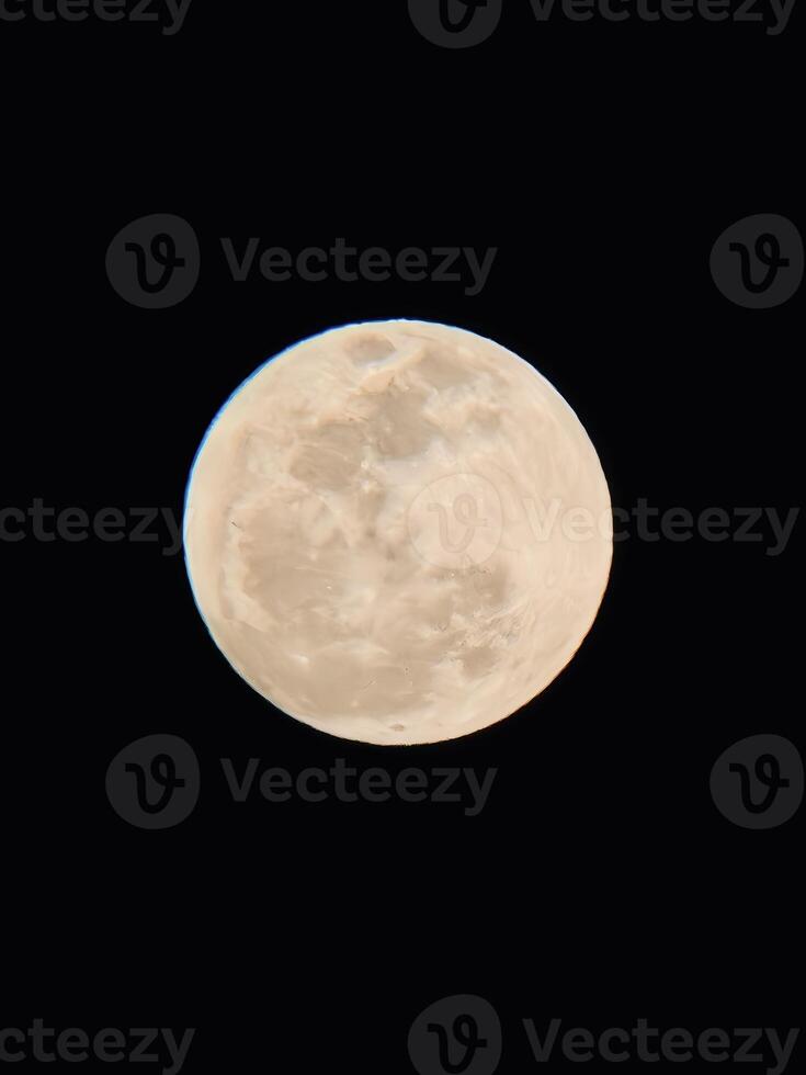 A Striking Close-Up of the Cratered Full Moon Against a Deep Black Night Sky photo