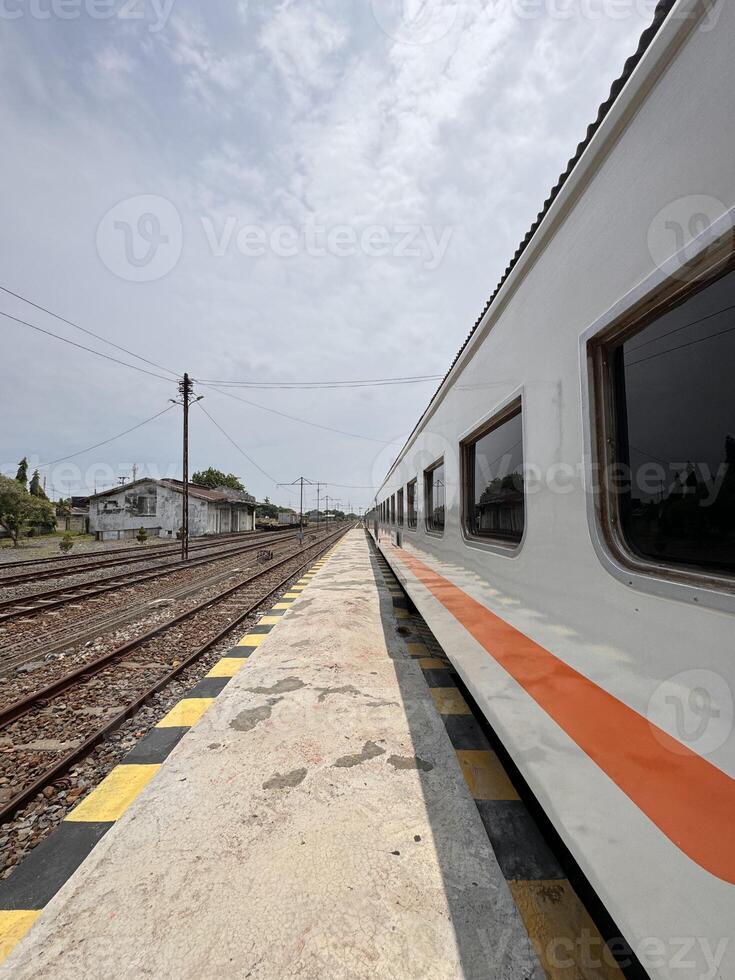 Train Parked at Empty Railway Station Platform photo