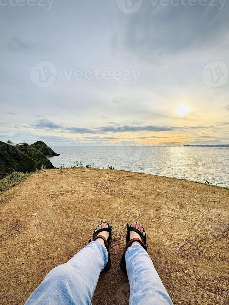 Relaxing at Sunset on a Cliff Edge photo