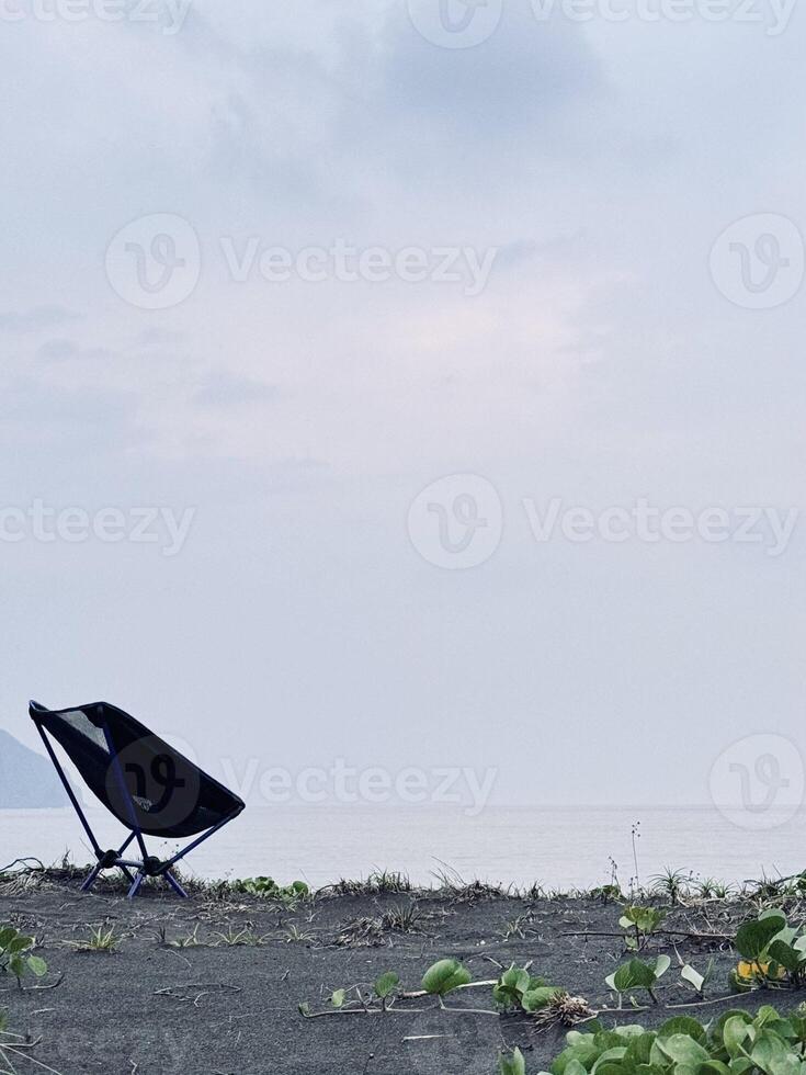 Solitary Chair on Overcast Beach photo