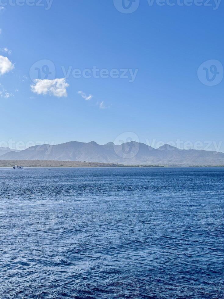 Scenic View of Bali Strait with Deep Blue Ocean and Clear Sky Overlooking the Island of Bali. Serene Seascape, Natural Horizon, Tropical Destination, Travel, Coastal Photography, Marine photo