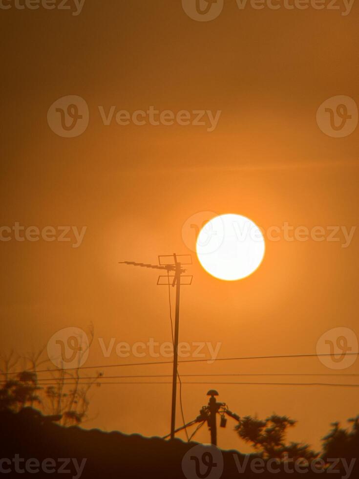 Silhouette of TV Antenna with Glowing Sunrise and Nostalgic Vibe photo