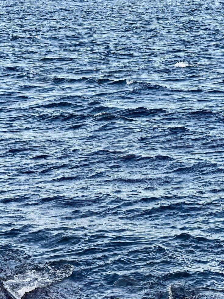 Close-Up of Ocean Waves and Ripples. Bali Strait Banyuwangi, Indonesia photo