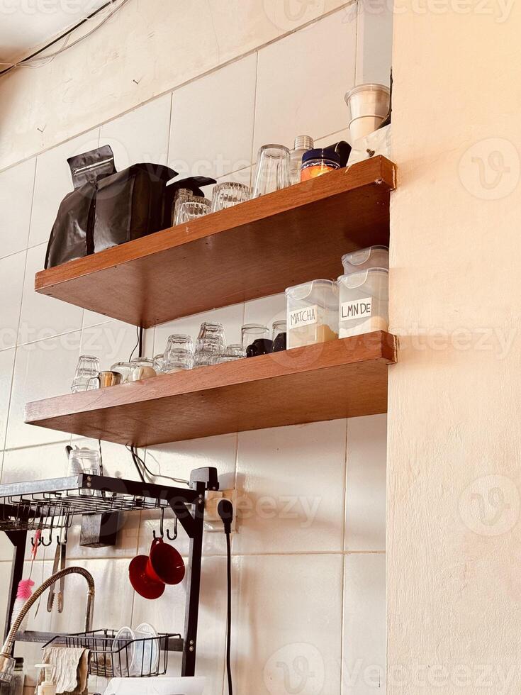 Kitchen Shelves with Glassware and Labeled Jars photo