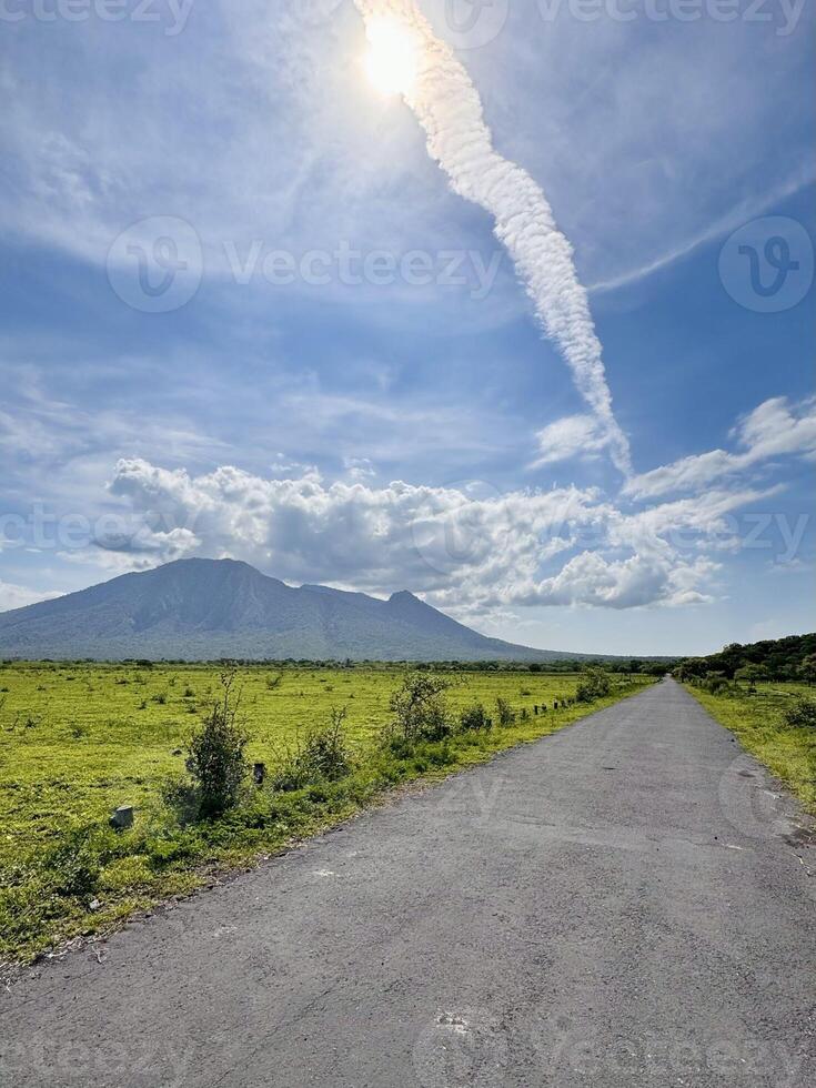 Volcano and Cloud Trail with Path in Foreground. Baluran National Park Situbondo. photo