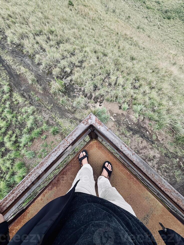 Standing on Rusty Platform Overlooking Grassy Landscape photo