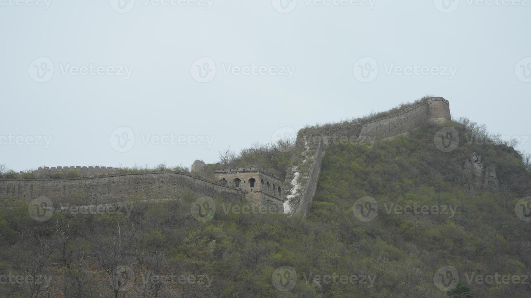 The broken watching tower built on the range of the mountains in China photo