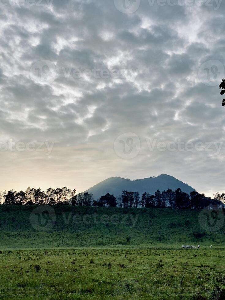 Serene Mountain Landscape Under Cloudy Sky. Kawah Wurung Ijen Geopark photo