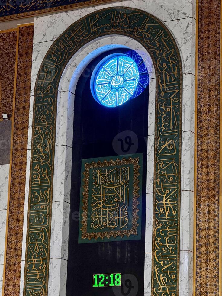 Intricate Arabic Calligraphy with Decorative Clock photo