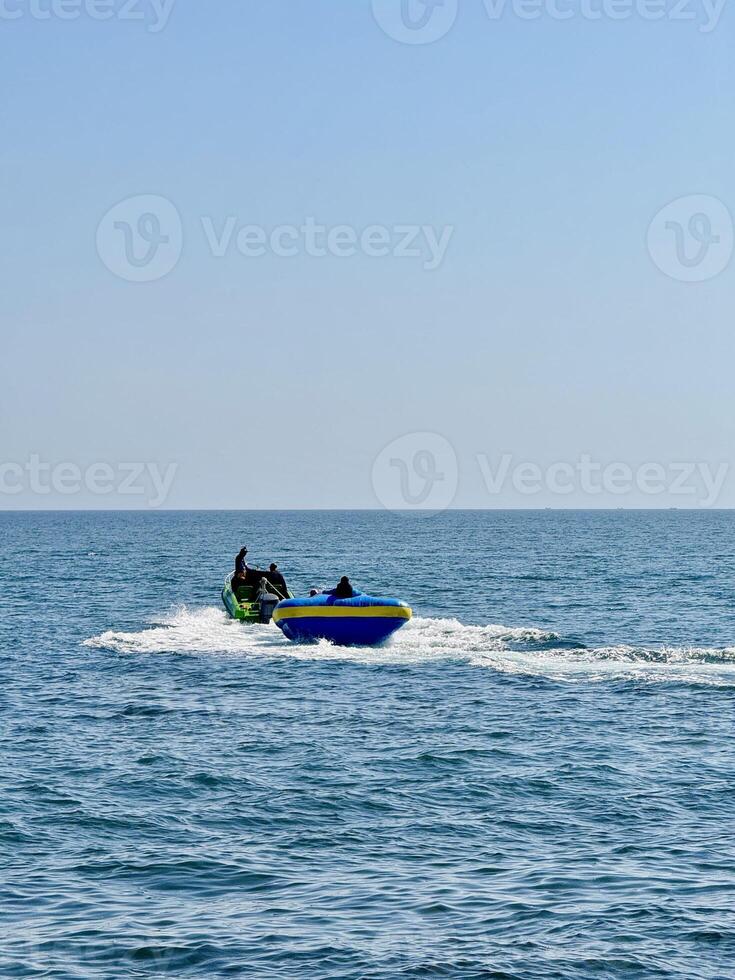 Inflatable Boat Ride on Calm Sea. Capture from Utama Raya Situbondo photo