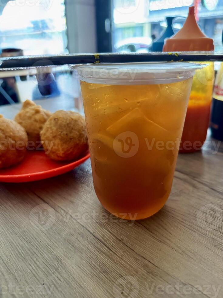 Iced Tea with Fried Snacks on a Wooden Table photo