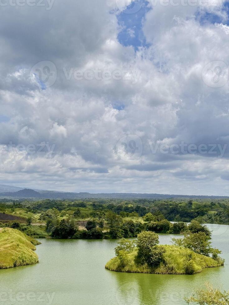 Scenic Lake with Islands and Dramatic Cloudy Sky. Bajulmati Dam Situbondo photo