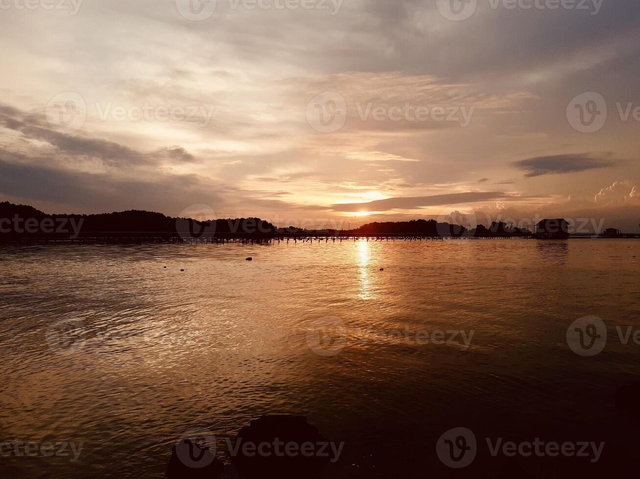 Serene Sunrise Over Calm Lake at Dawn photo