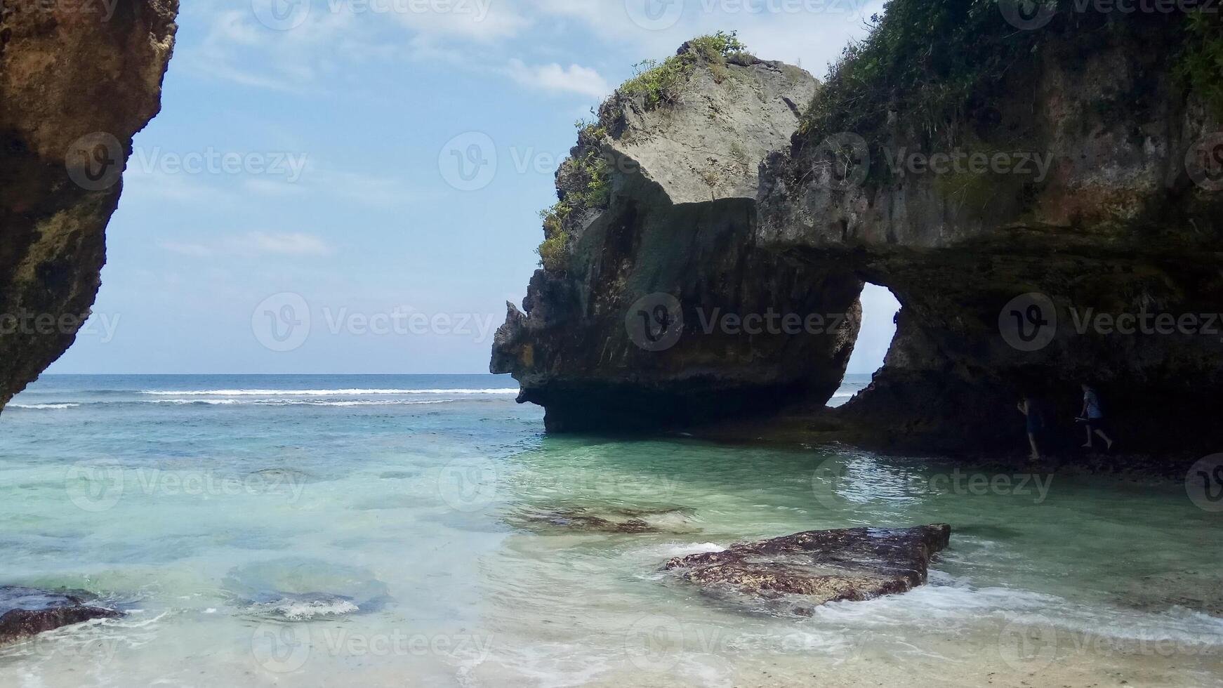 Scenic Coastal Rock Formations with Turquoise Waters. Suluban Beach Bali. photo