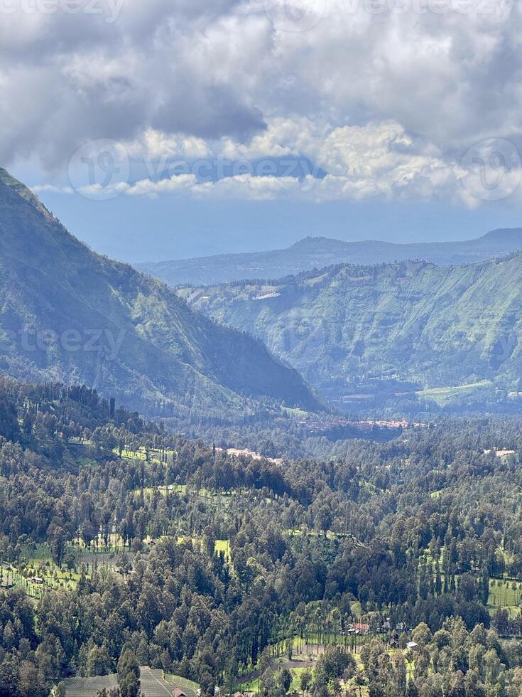 Lush Green Mountain Landscape Under Cloudy Sky. Seruni Point Bromo photo