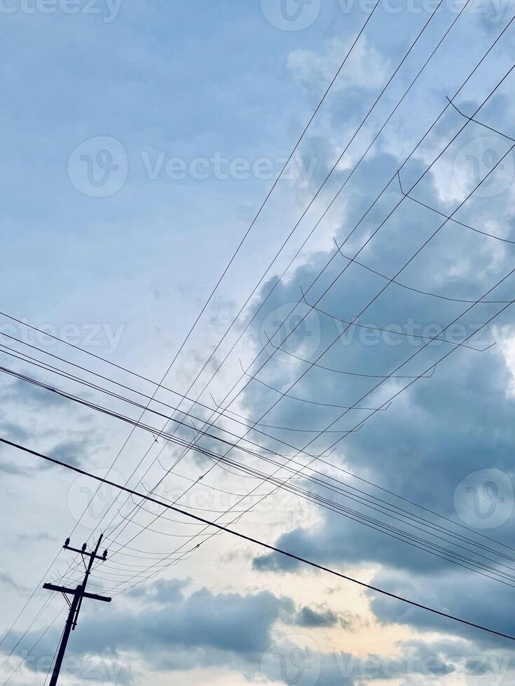 Intersecting Power Lines Against a Cloudy Sky photo