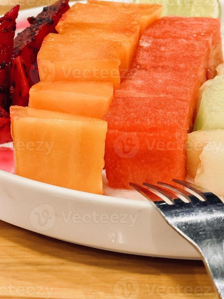 Assorted Fresh Fruit Slices on a Plate photo