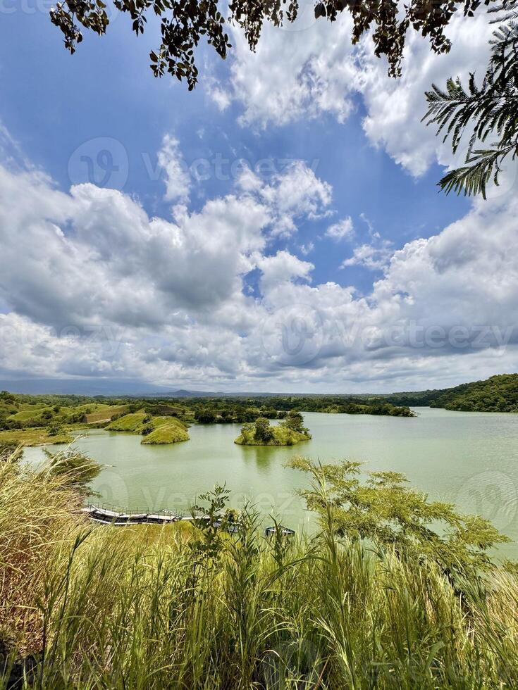 Turqoise Lake with Islands and Cloudy Sky. Bajulmati Dam Situbondo photo