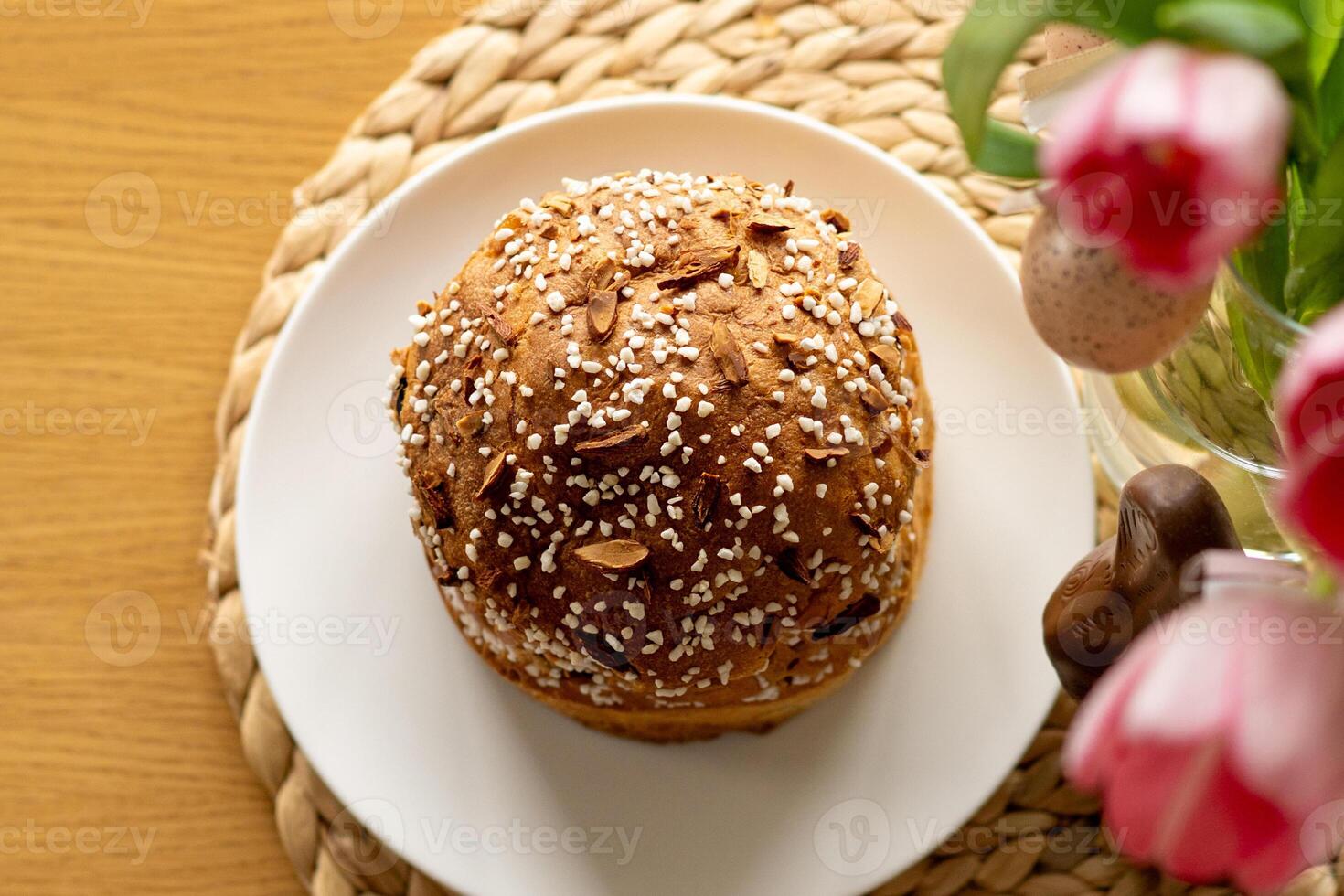 Happy Easter. Stylish easter cake, eggs on a table with spring flowers. photo