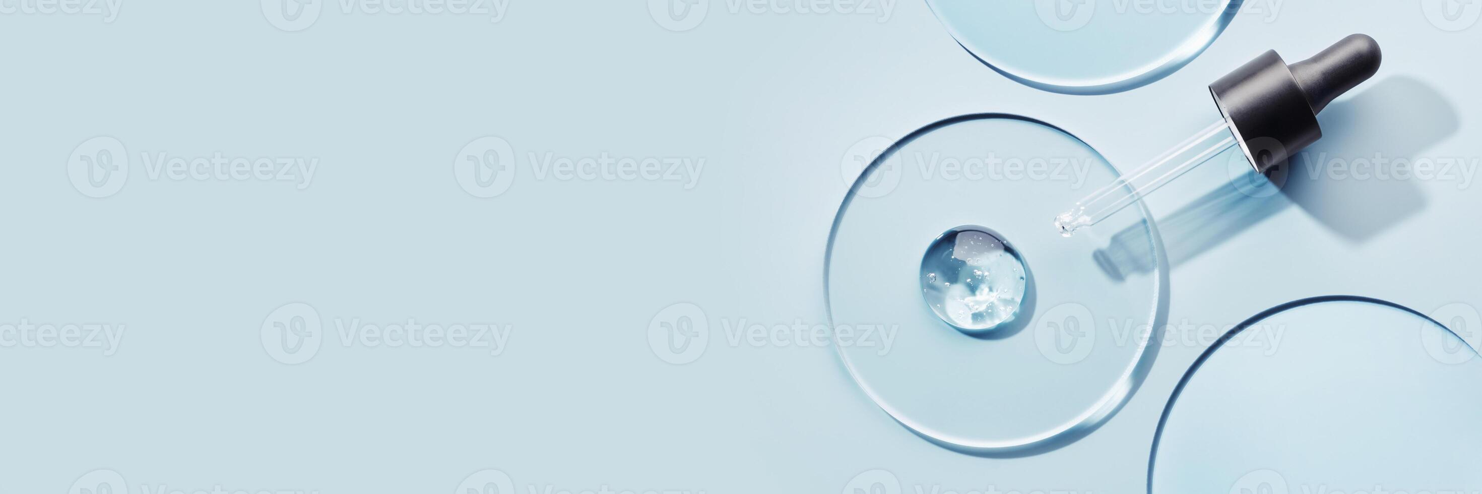 Pipette with sample of gels cosmetic product in petri dish on blue banner, hard shadows photo