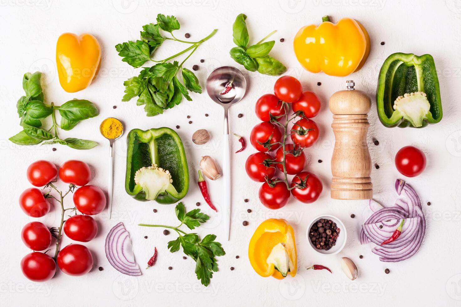 Variety of fresh vegetables, spice mill and spoon with olive oil. Food background and cooking concept photo