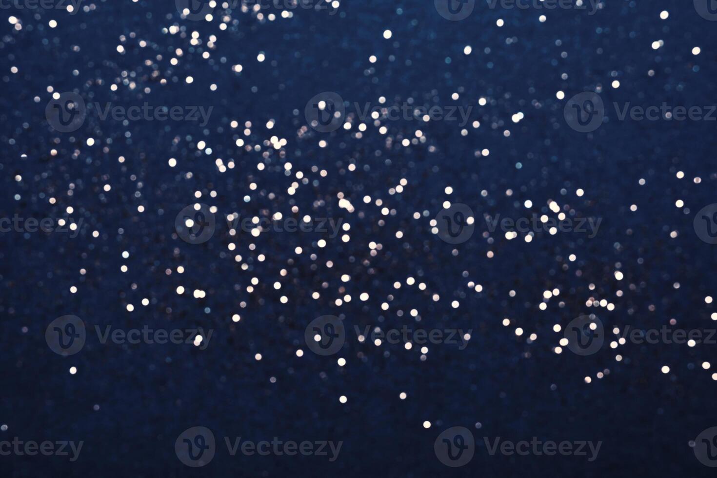 Festive Blue background of silver glitter lights. Winter blurred abstraction photo