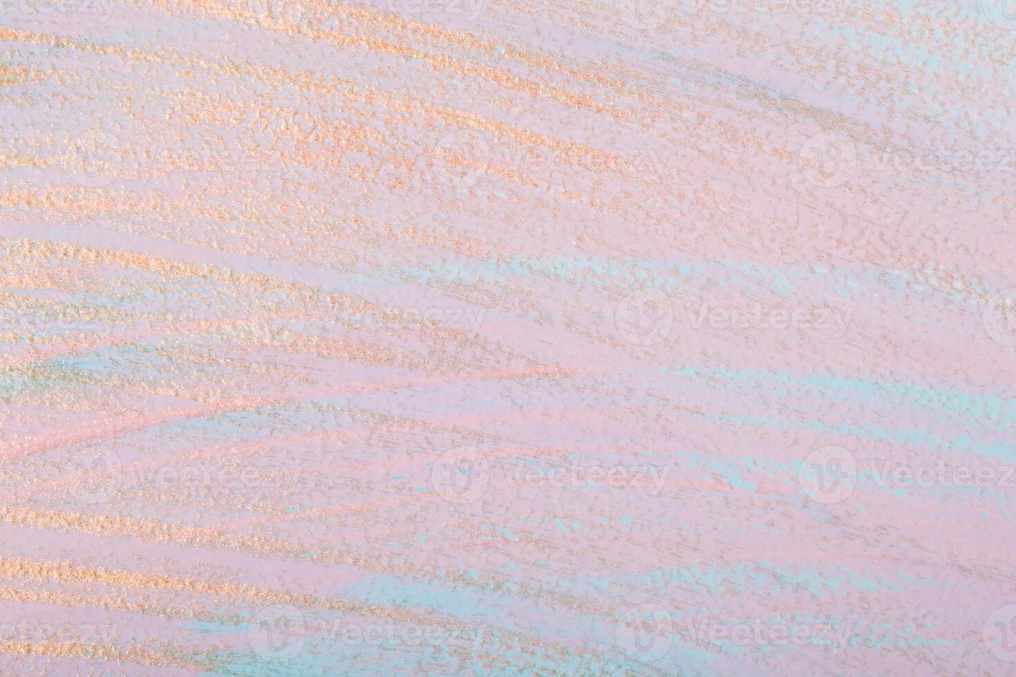 Golden brush strokes on pink pastel background. Dry brush technique. Hand painted background photo