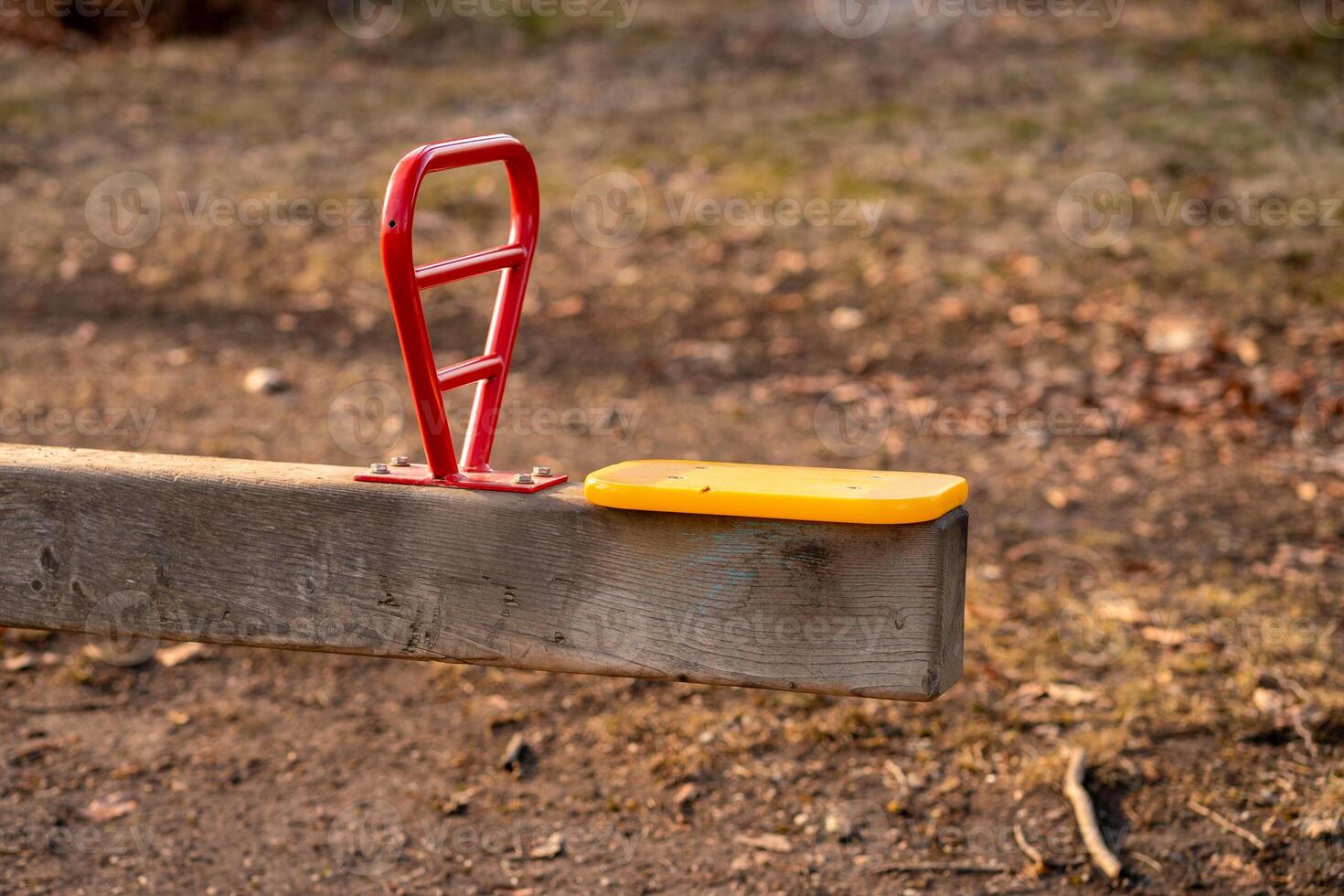 Metal swing on a playground in a park in early spring, side view of the seat photo